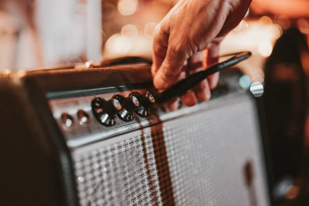 istock Male hand touching an amplifier 1470983483