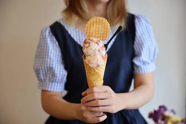 istock Young woman hand with holding ice cream cone 1470984030