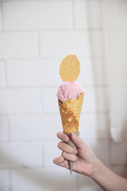 istock Young woman hand with holding ice cream cone 1470984122