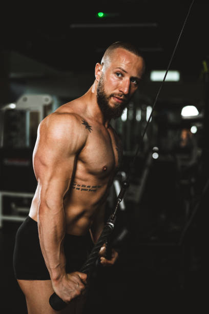 istock Man Doing Training On Machine For His Triceps Muscle At The Gym 1470984504