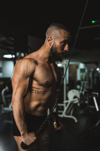 istock Man Doing Training On Machine For His Triceps Muscle At The Gym 1470984519