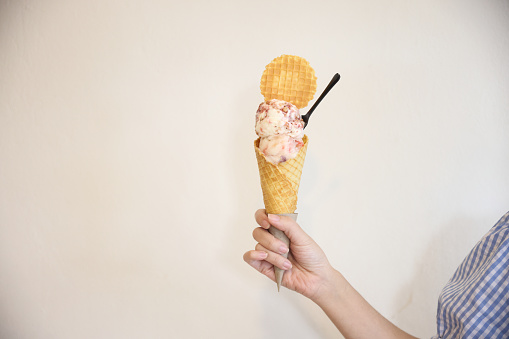 Young woman hand with holding ice cream cone