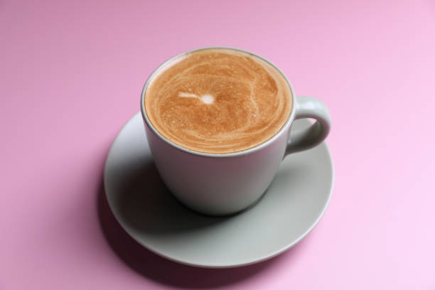 istock hot cappuccino with latte art isolated in pink background 1470985554