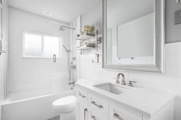 istock A bathroom with a white cabinet, cozy decorations, and herringbone tile shower. 1470985689