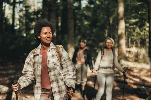 Mature black woman hiking through the mountains with her friends.