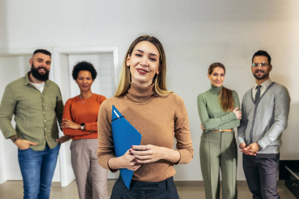 istock Successful group of business people at modern office looking at camera. 1470985817