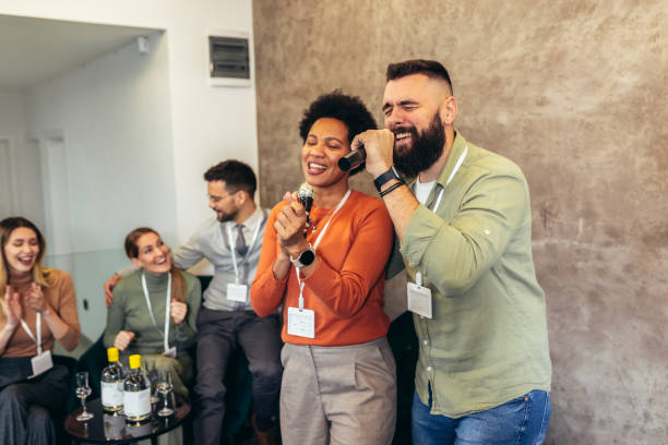 istock Business people singing karaoke in modern office 1470985999