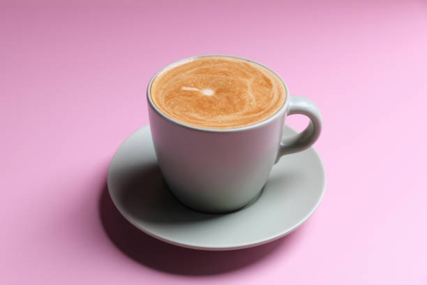 istock hot cappuccino with latte art isolated in pink background 1470986597