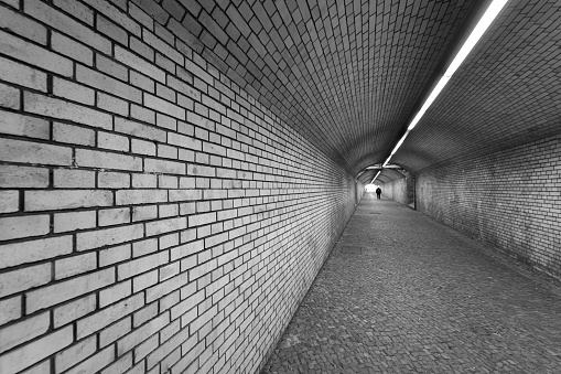 Man Walking In Underground Walkway