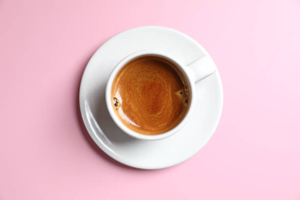 istock White cup of coffee espresso isolated on pink background 1470986784
