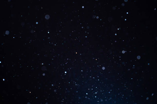 bildbanksillustrationer, clip art samt tecknat material och ikoner med natural organic dust particles floating on a sunbeam on black background. - particles