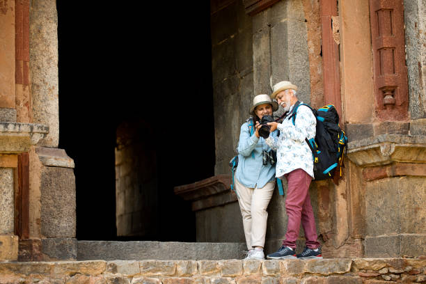 istock Senior couple at historic structure watching photos on camera during vacation post retirement 1470988414