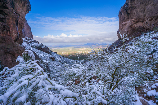 The rugged landscape on Siphon Draw Trail in The Superstition Mountains blanketed in snow during a winter storm at Lost Dutchman State Park
