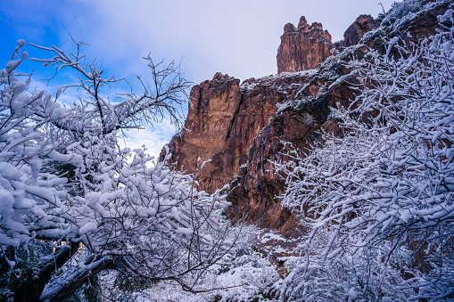 The rugged landscape on Siphon Draw Trail in The Superstition Mountains blanketed in snow during a winter storm at Lost Dutchman State Park