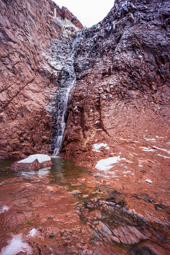 A waterfall in the Superstition Mountains flows during a winter storm in Lost Dutchman State Park