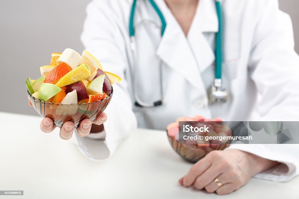 Professional help Doctor help to make the best choice in vitamins Apple - Fruit Stock Photo