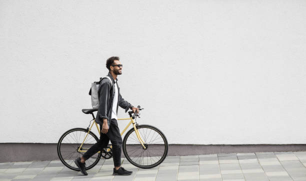 Handsome young man with bicycle in a city