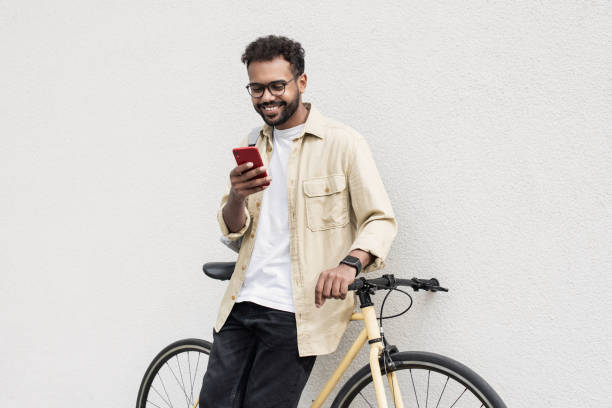 istock Happy man with bicycle using smart phone in a city 1470989781