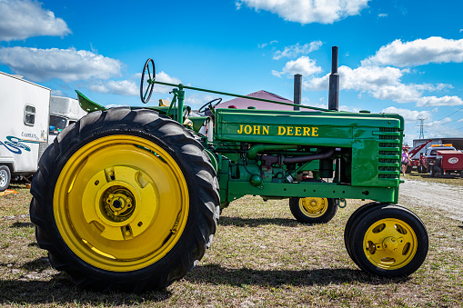 Fort Meade, FL - February 24, 2022: Low perspective side view of a 1943 John Deere Model H Tractor at a local tractor show.