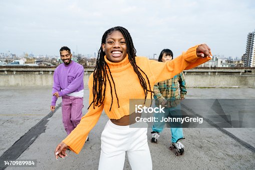 istock Young Black woman and roller skating friends 1470989984