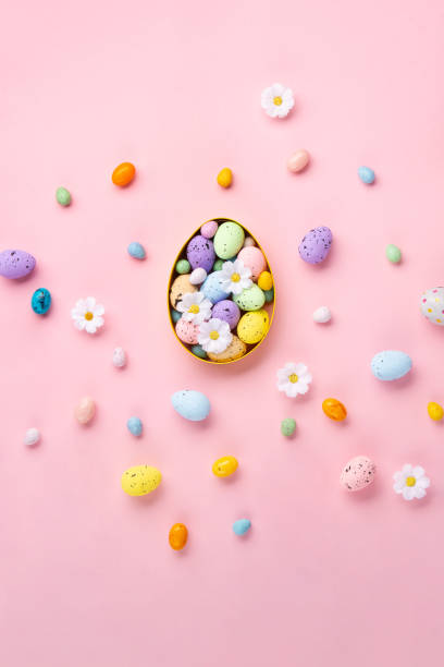istock Easter Eggs with Sweets and Spring Flowers on Pink Background 1470990020
