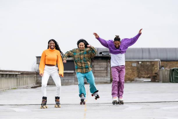 istock Black and Asian roller skaters having fun on rooftop 1470990184