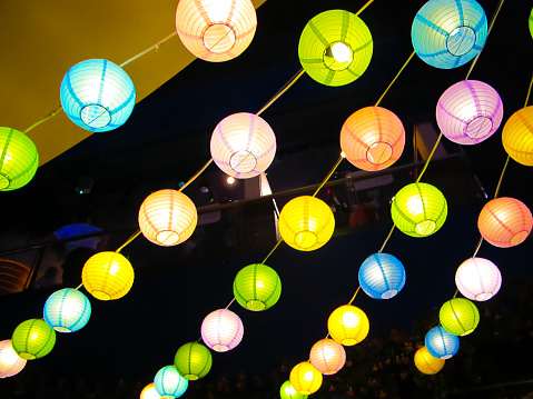 Colorful yard lanterns strung up at a party. These lanterns are also known as Chinese lanterns