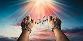 istock Hands in fists breaking a chain freedom. The concept of gaining freedom. 1470991458