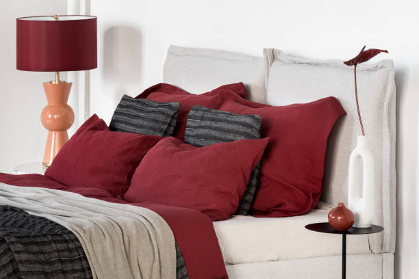 istock Comfortable bed with red bedclothes and pillows 1470992046