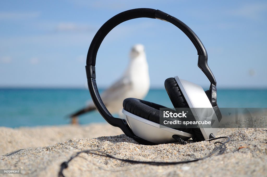 Beach sounds Here is an image that screams relaxation. Tune out the world with your favorite tunes and enjoy the scenic view of the ocean. This would make a great post card or maybe a greeting card. UBB For Image ID:12127068 Beach Stock Photo