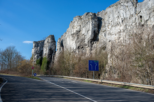 Old rocks in Namur with highway near it. Road signs