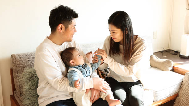 istock Parents relaxing with their baby on the sofa 1470997364