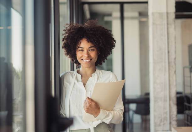 istock Beautiful woman standing in office 1470998353
