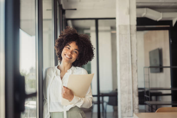 istock Beautiful woman standing in office 1470998362