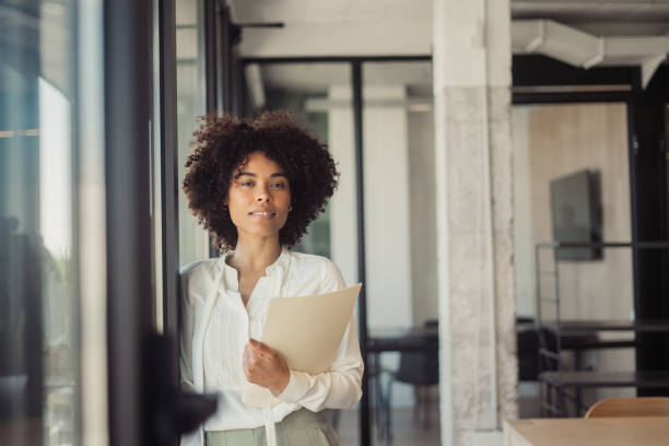 istock Beautiful woman standing in office 1470998363