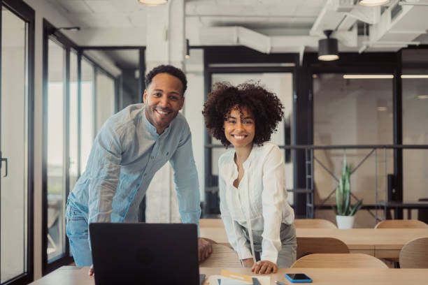 istock Man and woman standing side by side in the office 1470998412