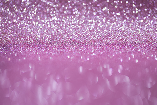 Shiny background, shimmering texture full of reflections and tinsel in color pink.