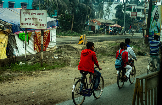 Village People in the city street riding their bicycle. Dankuni West Bengal India South Asia Pacific February 18, 2022