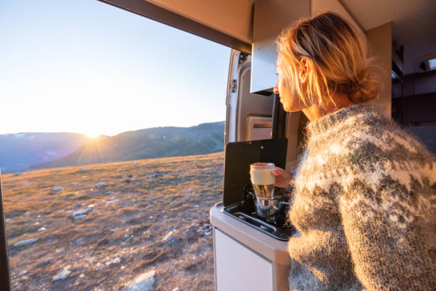 istock Woman relaxing with a hot beverage, van life concept 1471001512