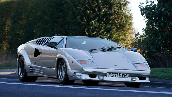 Bicester,Oxon,UK - Oct 9th 2022. Classic 1988 silver Lamborghini Countach driving on an English country road