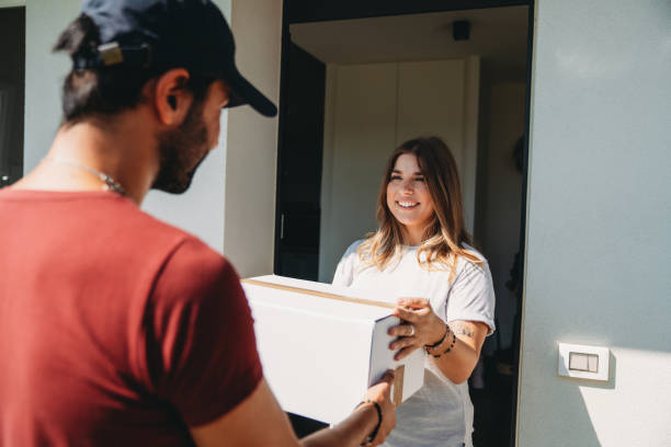 istock Delivery man is giving a box to a woman 1471001925