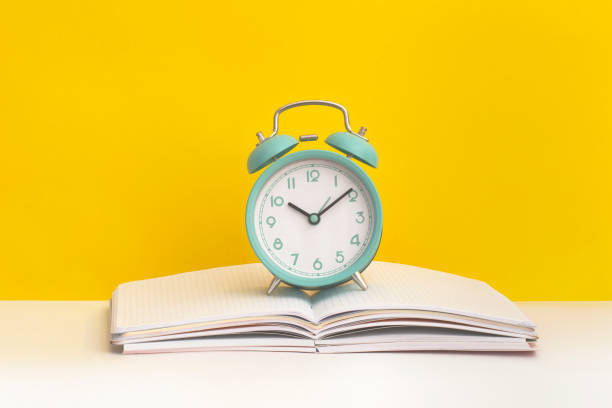 istock Notebook and alarm clock on yellow background. Top view. Flat lay. Back to school concept. 1471003881