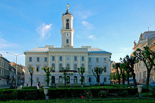 Chernivtsi , Ukraine: Chernivtsi City Hall seen from Central Square. The city council building is painted blue and white and has a tall clock tower.