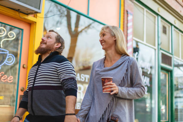 Millennial Couple Outdoors in Small Town America Having Coffee and Pastries Photo Series Western Colorado Dating and Relationships Millennial Heterosexual Couple Outdoors in Small Town America Having Coffee and Pastries Americana Photo Series small town america stock pictures, royalty-free photos & images