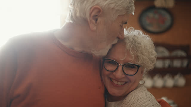 SLO MO Portrait video of an Elderly Couple Sharing Tender Moments in Vintage Kitchen