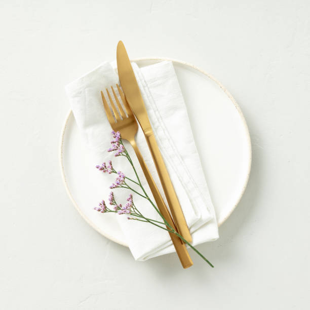 istock Gold Cutlery with eucalyptus branches on white plate with napkin over light grey Background. Minimalistic design. Copy Space banner 1471005127