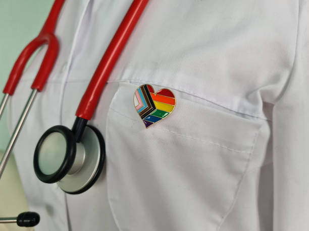 Silhouette of doctor in white coat with stethoscope and LGBT badge on pocket Silhouette of doctor in white coat with stethoscope and LGBT badge on pocket concept lgbtqia people stock pictures, royalty-free photos & images