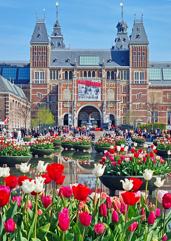 Amsterdam, Netherlands-April, 11. 2022: Rijksmuseum on Museumplein with crowds of tourists.