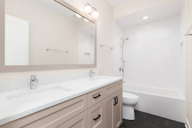 istock A bathroom with a brown cabinet and hexagon and subway tiles. 1471010741