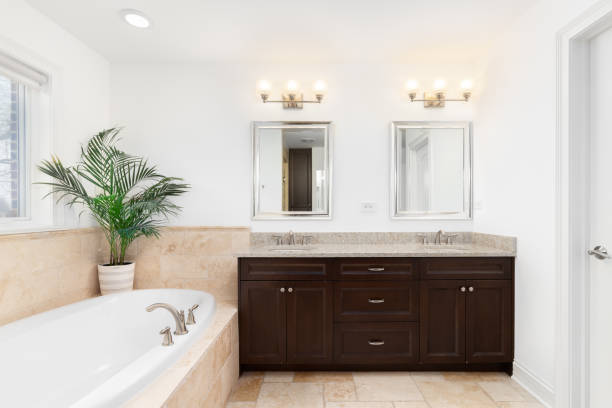 istock A bathroom with a wood cabinet and tan tiles. 1471010817